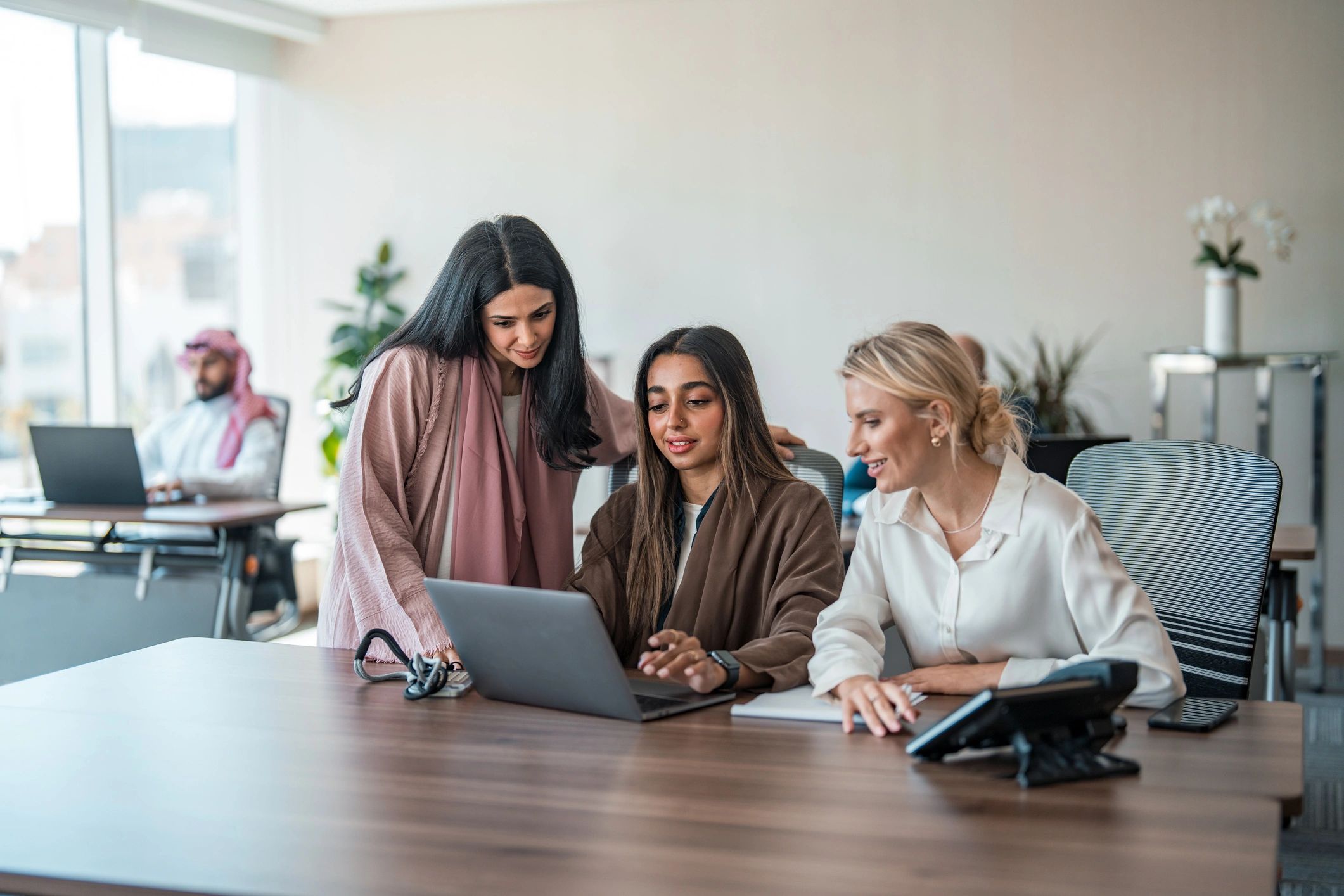 Business professionals reviewing laptop solutions together
