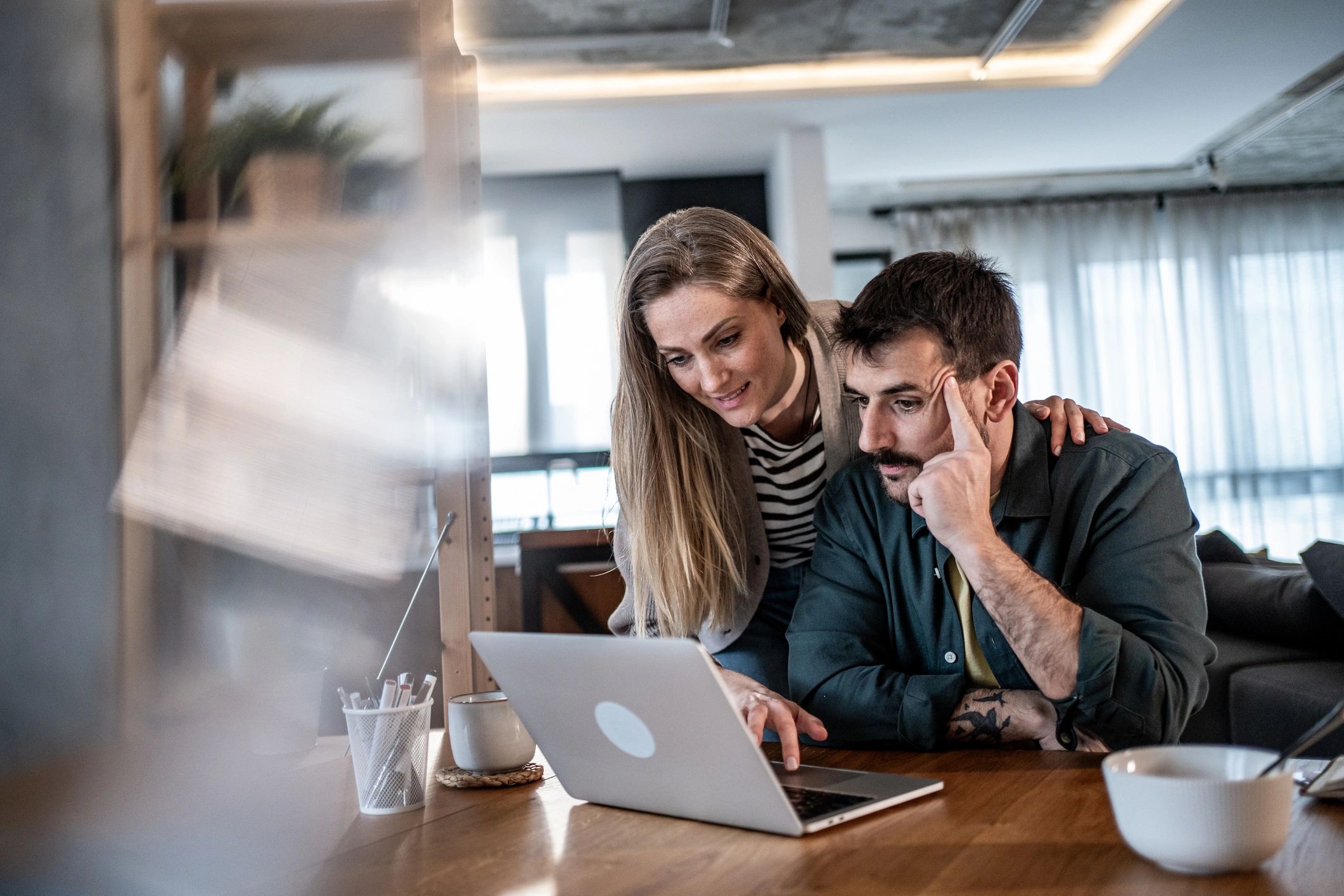 People getting help with a laptop at home
